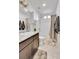 Updated bathroom with granite look counter, tiled shower, tub, and modern fixtures at 240 S Oak Hill St, Aurora, CO 80018