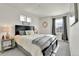Bright bedroom features a large bed with white bedding, grey accents, and natural light at 240 S Oak Hill St, Aurora, CO 80018