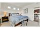 Comfortable bedroom boasts a large bed with patterned bedding and an adjacent dark dresser at 240 S Oak Hill St, Aurora, CO 80018