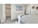 Sunlit bedroom featuring soft carpet, neutral walls, walk-in closet, and a comfortable bed at 240 S Oak Hill St, Aurora, CO 80018