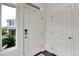 Bright entryway features a white front door, hardwood floors, and a large window with a view of the outdoors at 240 S Oak Hill St, Aurora, CO 80018