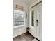 Bright foyer featuring a white door, window, wood-look floors, and charming decor at 240 S Oak Hill St, Aurora, CO 80018