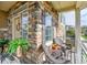 Relaxing front porch with wicker furniture and stone accents at 240 S Oak Hill St, Aurora, CO 80018