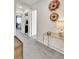 Inviting hallway featuring gray carpet, decorative wall baskets, and a modern side table at 240 S Oak Hill St, Aurora, CO 80018