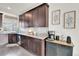 Gourmet kitchen with sleek stainless steel appliances, custom cabinetry, and a granite countertop for food preparation at 240 S Oak Hill St, Aurora, CO 80018