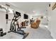 Wide view of a multi-purpose living area complete with workout equipment, a tv, and office space at 240 S Oak Hill St, Aurora, CO 80018
