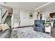 Open-concept living room featuring hardwood floors, a staircase, and seamless access to the kitchen at 240 S Oak Hill St, Aurora, CO 80018