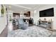 Open-concept living room with dark wood floors, a cozy recliner, and seamless access to the kitchen at 240 S Oak Hill St, Aurora, CO 80018