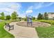 Neighborhood playground area with benches, play equipment, and manicured landscaping on a sunny day at 240 S Oak Hill St, Aurora, CO 80018