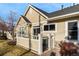 Charming home exterior with a fenced patio, updated paint, and well-kept landscaping at 6606 S Reed Way # B, Littleton, CO 80123