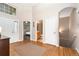 Entryway featuring hardwood floors, high ceilings, and an arched doorway at 6606 S Reed Way # B, Littleton, CO 80123
