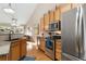 Bright kitchen boasts stainless steel appliances, granite counters, and hardwood floors at 6606 S Reed Way # B, Littleton, CO 80123