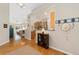 Open-concept living room with kitchen featuring hardwood floors and plenty of natural light at 6606 S Reed Way # B, Littleton, CO 80123