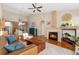 Open living room featuring a fireplace, high ceilings, and hardwood floors at 6606 S Reed Way # B, Littleton, CO 80123