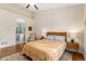 Comfortable main bedroom featuring high ceilings, ceiling fan, and ensuite bath access at 6606 S Reed Way # B, Littleton, CO 80123