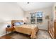 A bright main bedroom with a large window providing natural light at 6606 S Reed Way # B, Littleton, CO 80123