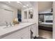 Bright bathroom featuring a vanity with white cabinets and view to main bedroom at 7640 S Monaco W Cir, Centennial, CO 80112