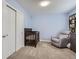 Bedroom room featuring a wooden crib, gray dresser, soft armchair, and ample closet space at 7640 S Monaco W Cir, Centennial, CO 80112