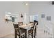 Charming dining area with hardwood floors, modern lighting, and easy access to the kitchen and bedroom at 7640 S Monaco W Cir, Centennial, CO 80112