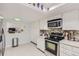 Well-equipped kitchen featuring white cabinets, stainless steel appliances, and a stylish mosaic backsplash at 7640 S Monaco W Cir, Centennial, CO 80112