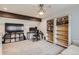 Large office space featuring bookcases, a desk with computer, and tv with storage at 7640 S Monaco W Cir, Centennial, CO 80112