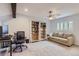 Spacious office featuring built-in bookcases, a comfortable sofa, and a ceiling fan at 7640 S Monaco W Cir, Centennial, CO 80112