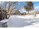 Snowy backyard landscape with zen garden and pathways at 995 S Upham St, Lakewood, CO 80226