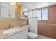 Clean basement bathroom with updated vanity and tiled shower/tub combo at 995 S Upham St, Lakewood, CO 80226