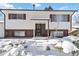 Ranch style home with snow-covered landscaping at 995 S Upham St, Lakewood, CO 80226