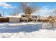 Snow covered lawn and charming ranch home with attached garage at 995 S Upham St, Lakewood, CO 80226