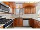 Modern kitchen with stainless steel appliances and wood cabinets at 995 S Upham St, Lakewood, CO 80226