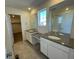 Main bathroom with double vanity, large mirror, and walk-in shower at 191 Freemont Ct, Brighton, CO 80601