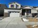 Two-story house with attached garage, stone accents, and a landscaped yard at 191 Freemont Ct, Brighton, CO 80601