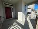 Covered front porch with red door and gray siding at 191 Freemont Ct, Brighton, CO 80601