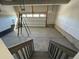 Unfinished two car garage with concrete floor and stairs leading down at 191 Freemont Ct, Brighton, CO 80601