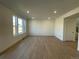 Spacious living room with hardwood floors and large windows at 191 Freemont Ct, Brighton, CO 80601