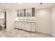 Basement bar with white cabinets, granite countertop, and mosaic backsplash at 10767 Mountshire Cir, Highlands Ranch, CO 80126