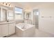 Main bathroom with double sinks and a large bathtub at 10767 Mountshire Cir, Highlands Ranch, CO 80126