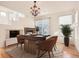 Bright dining room with hardwood floors, chandelier, and a fireplace at 10767 Mountshire Cir, Highlands Ranch, CO 80126