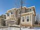 Two-story house with beige siding, stone accents, and a two-car garage at 10767 Mountshire Cir, Highlands Ranch, CO 80126