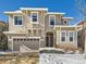 Two-story house with beige siding, stone accents, and a two-car garage at 10767 Mountshire Cir, Highlands Ranch, CO 80126