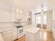 Kitchen with white cabinets, island, and breakfast nook at 10767 Mountshire Cir, Highlands Ranch, CO 80126