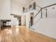 Two-story living room with hardwood floors, fireplace, and open staircase at 10767 Mountshire Cir, Highlands Ranch, CO 80126