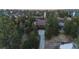 Picturesque aerial view of a brown home nestled among mature trees at 8140 Lightening View Dr, Parker, CO 80134