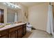 Well-lit bathroom featuring a vanity with sink, toilet, and shower/tub combination at 8140 Lightening View Dr, Parker, CO 80134