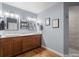 This bathroom features a double vanity, granite countertops and light wood floors and is brightly lit at 8140 Lightening View Dr, Parker, CO 80134