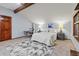 Brightly lit bedroom features carpet flooring, a sloped ceiling and an adjacent desk area at 8140 Lightening View Dr, Parker, CO 80134