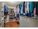 This is a well-organized walk-in closet with custom shelving and hanging rods for maximum storage at 8140 Lightening View Dr, Parker, CO 80134