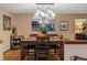 Dining room with modern lighting fixture, wood floors, and views to living area, ideal for entertaining at 8140 Lightening View Dr, Parker, CO 80134