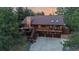 Aerial view of a charming home with a spacious deck, three-car garage, and lush surrounding trees at 8140 Lightening View Dr, Parker, CO 80134